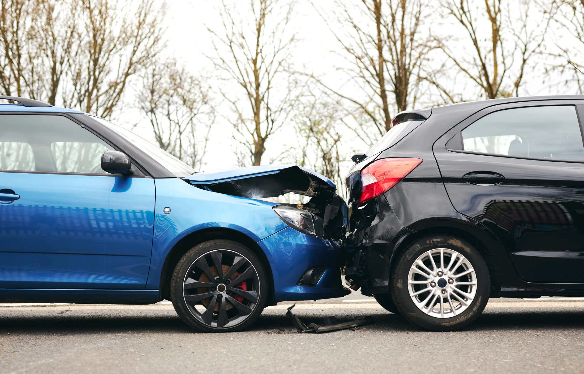 blue car hit black car from behind